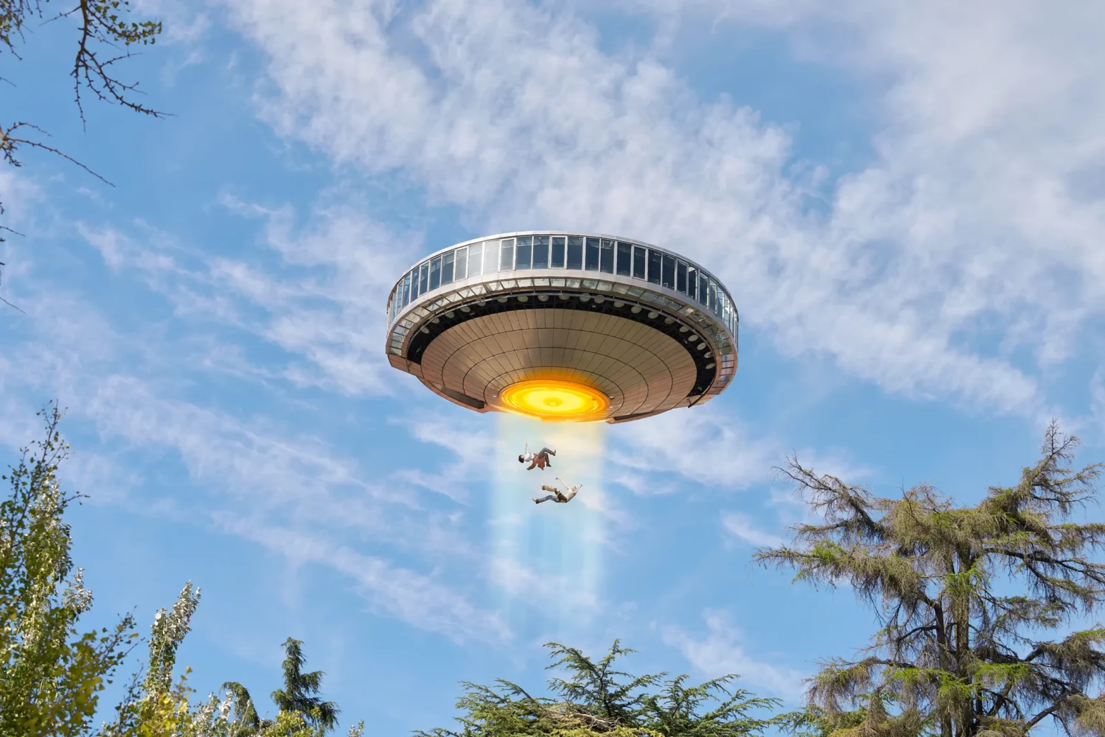 Flying saucer hovering over trees against a blue sky in a science-fiction fashion editorial.