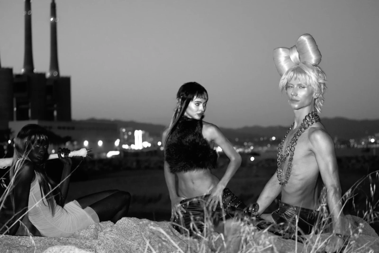 Black-and-white rooftop group portrait of fashion models in experimental black-and-white outfits.